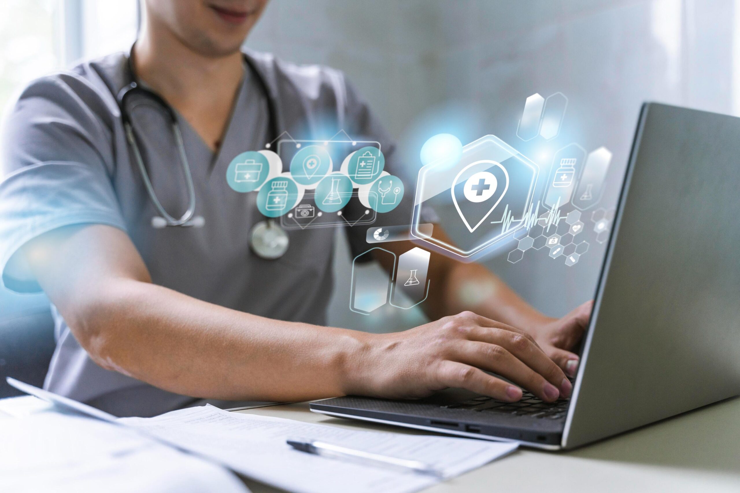 healthcare cybersecurity healthcare professional wearing a stethoscope typing on a laptop with icons coming from screen to depict sensitive patient data